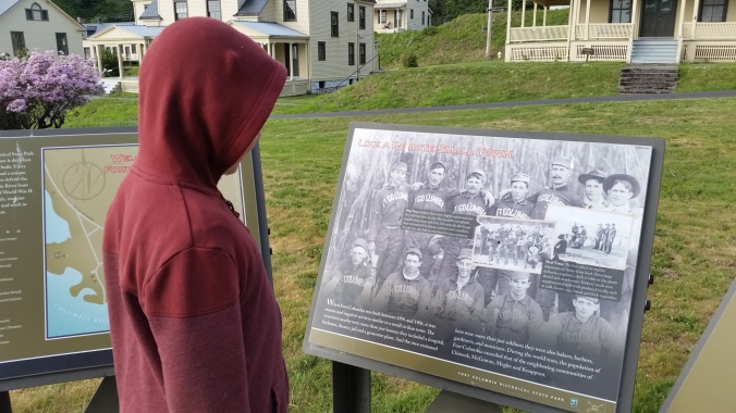 Evan studies an informational sign at Fort Columbia